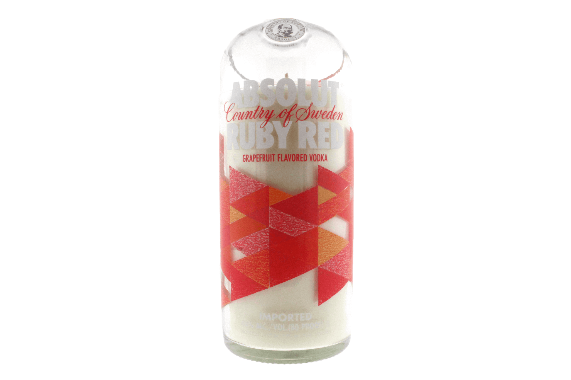 A Recycled Vodka Candle – Absolut Red Ruby, crafted from an Absolut Ruby Red grapefruit vodka bottle with a red and orange geometric label, stands upright on a white background—the perfect unique hand poured soy candle.