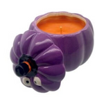 The Ceramic Purple Halloween Pumpkin Candle w/ Hat Lid features cartoon eyes and a removable lid, revealing an orange fall-scented candle—perfect for adding festive charm to your Halloween decor.
