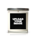 A white Customizable Photo Candle in a clear glass jar with a silver lid. The front label shows "UPLOAD YOUR IMAGE" in bold white text on a black background.