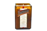 The Recycled Cointreau Liqueur Candle features a white hand-poured soy candle inside a repurposed brown Cointreau bottle, complete with its label on the front.