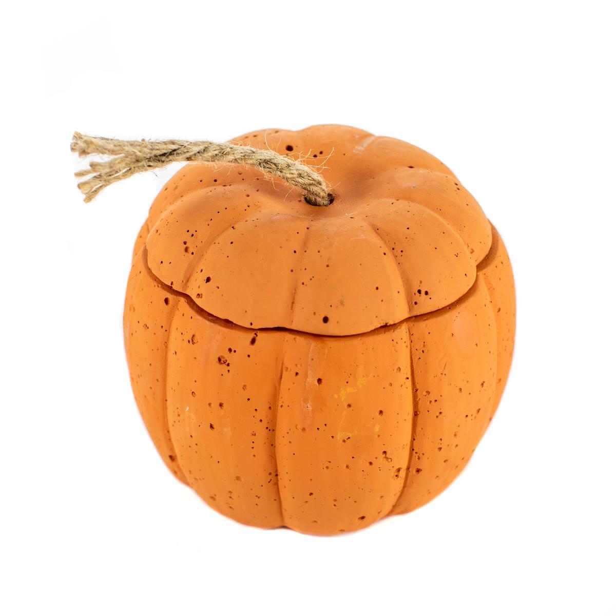 The Orange Cement Candle features a pumpkin-shaped, orange container with a removable lid and rope stem, shown against a white background.