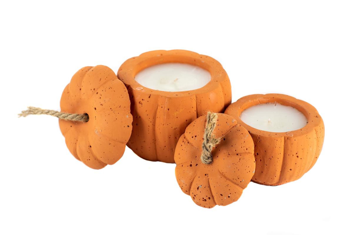 Three orange pumpkin-shaped candles, including the Orange Cement Candle and a custom candle with lids, are arranged on a white background.