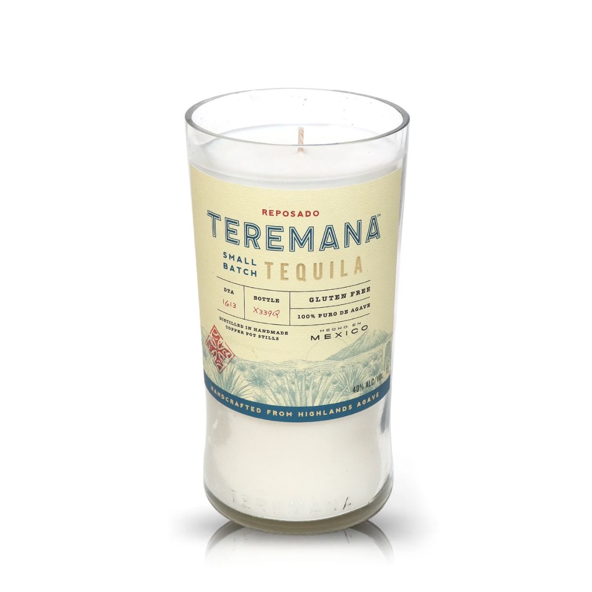 The Recycled Teremana Tequila Candle is a white candle in a glass crafted from repurposed tequila bottles, showcasing the original Teremana Tequila "small batch" reposado label with product details.