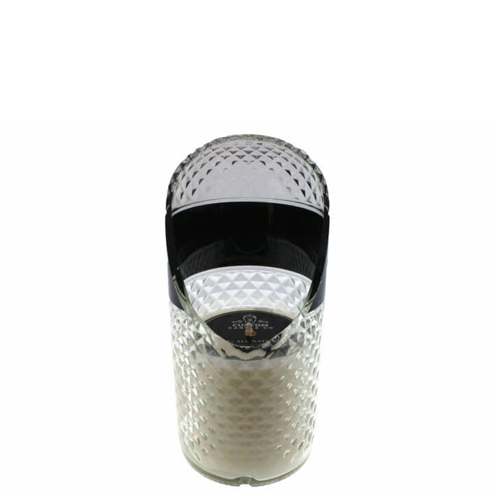 The Recycled Vodka Candle – Absolut features a clear, textured cylindrical container with a black, semi-open lid and white interior. Hand poured with all-natural soy, it ensures a clean burn.
