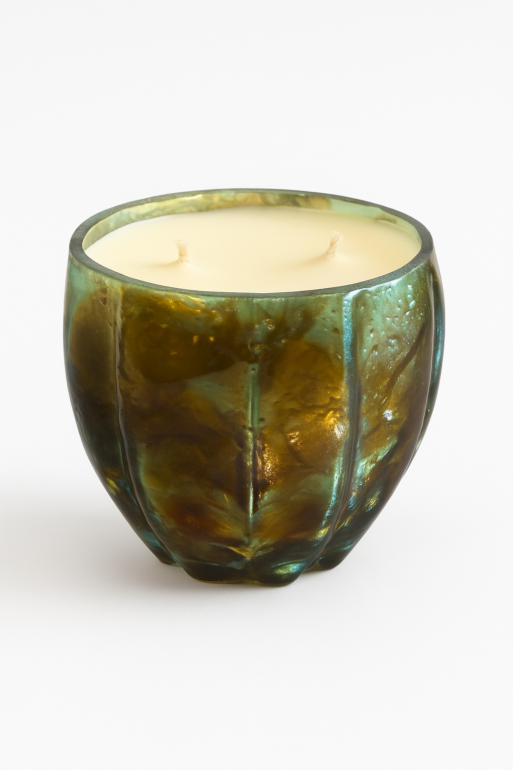 The Aqua Glow Candle features creamy wax with two unlit wicks in a green, textured glass holder, presented as a luxury scented candle set on a plain white background.