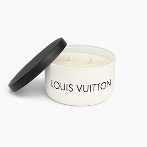 The Luxury White Two-Wick Candle – Inspired by Iconic Designer Style is presented in a round container with a black lid placed beside it.