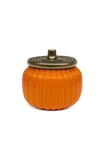 The Golden Pumpkin Candle features an orange, pumpkin-shaped ceramic container with a textured, metallic lid—an ideal autumn accent. Perfect for adding seasonal warmth to any space. Photographed against a white background.