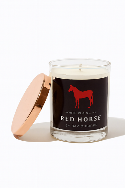 The Custom Red Horse Candle features a rose gold lid and a black label with a red horse silhouette and the text "Red Horse by David Burke, White Plains, NY.