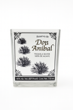 The Don Anibal Tequila Candle is upcycled from a 750ml Don Anibal Tequila Silver bottle with a white label, black agave art, and 40% Alc. Vol., made using natural soy wax for an eco-friendly touch.