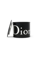 The Designer Black Paint Can Candle is a black, cylindrical candle with a partially open lid and "Dior" in large white letters, hand poured from soy for a luxurious, stylish touch to any space.