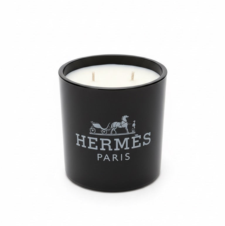 The Designer Paris Candle is a black luxury scented candle with two wicks and the brand logo on the front.