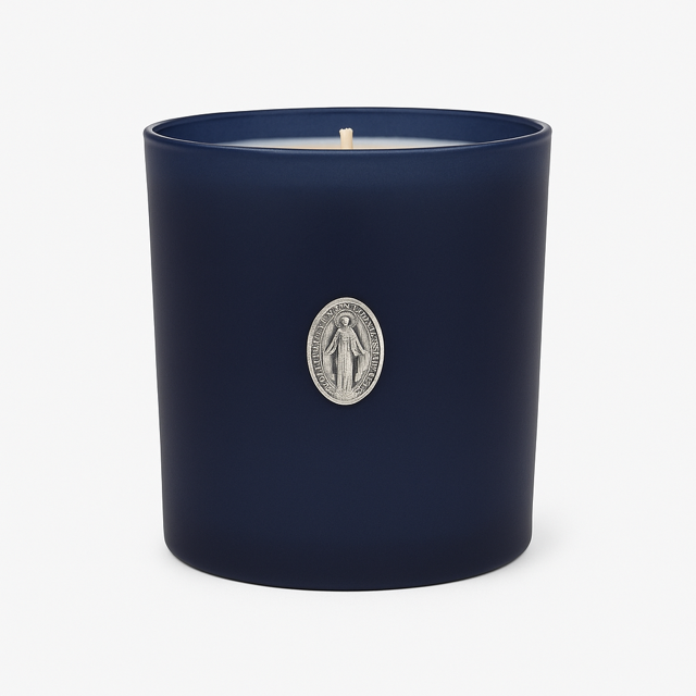 The Boxed Blessed Mother Candle is hand-poured with coconut-apricot wax in a navy matte glass, featuring a silver religious medallion, for a serene and scented experience.