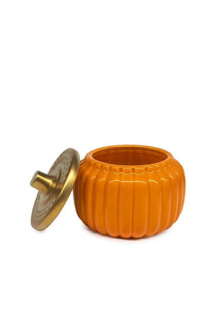 The Golden Pumpkin Candle, an orange pumpkin-shaped ceramic container with a gold-colored lid, sits on a white background—perfect as an autumn accent.