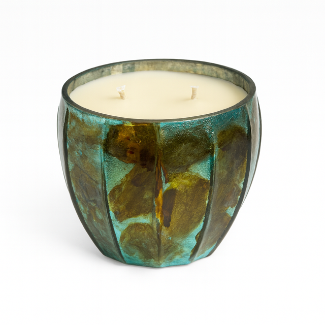 The Aqua Glow Candle features green and brown glass, two wicks, off-white wax, and a luxurious scent, shown on a white background.