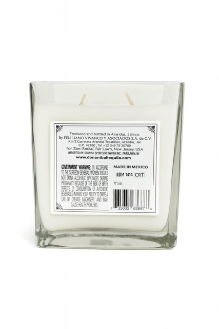 The Don Anibal Tequila Candle features a square glass design with white natural soy wax inside and a back label for manufacturing and safety info. Made from recycled materials, it's an eco-friendly addition to your space.