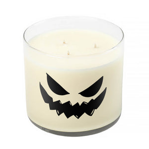 The 3 Wick Clear Tumbler Halloween Candle with Scary Pumpkin (Face #4) features a white scented candle in a clear glass jar with a jagged jack-o’-lantern face—perfect for Halloween décor.