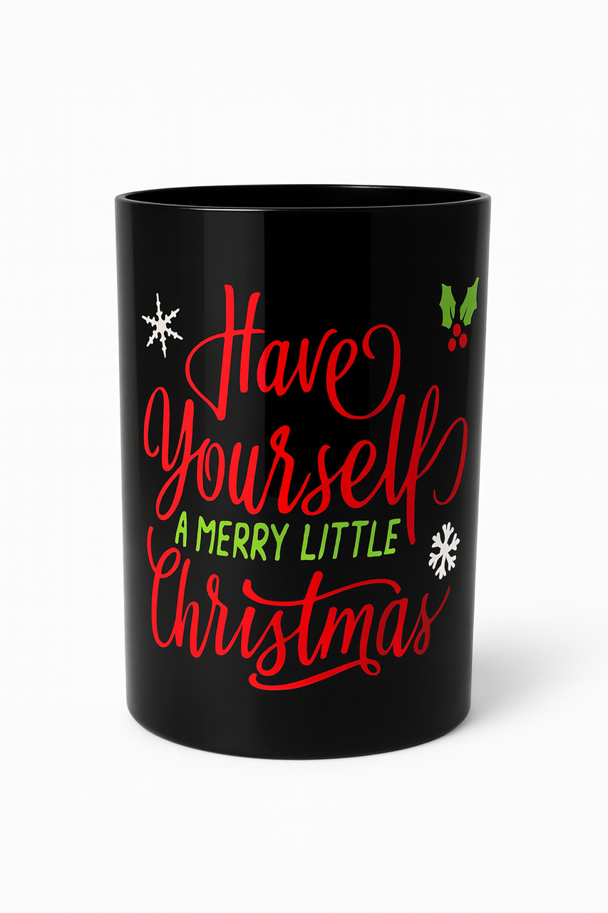 The "Have Yourself A Merry Little Christmas" 3 Wick Candle features a festive black mug with red and green script, snowflake accents, and a holly graphic—perfect for holiday decor.