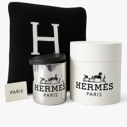 The Designer Paris Gift Set features a black Hermes cushion with an “H,” a metallic candle with black lid, a white box, and a “Paris” card—an elegant combination that pairs beautifully with a cotton throw for sophisticated home decor.