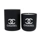 The Designer Ceramic Candle is a black soy candle with a white logo, shown beside its matching cylindrical reusable jar, displayed against a white background.