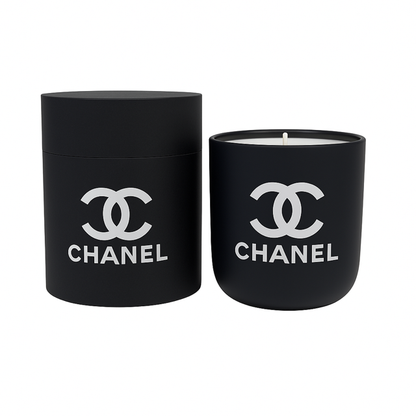 The Designer Ceramic Candle is a black soy candle with a white logo, shown beside its matching cylindrical reusable jar, displayed against a white background.