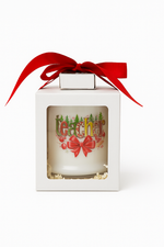The Teacher's Christmas Candle with Matches is labeled "teacher," made from all-natural wax, features holiday decorations, and comes in a white box with a clear window topped with a red ribbon.