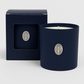 The Boxed Blessed Mother Candle, in dark blue coconut-apricot wax with a silver religious medallion, comes in a matching box featuring a window that displays the same medallion.