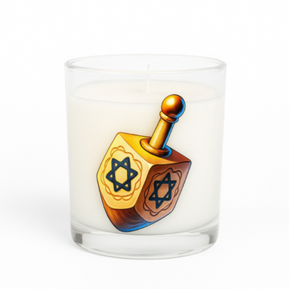 The Dreidel Candle is a white candle in a clear glass holder with a dreidel and Star of David design—an ideal Hanukkah decoration for your home.
