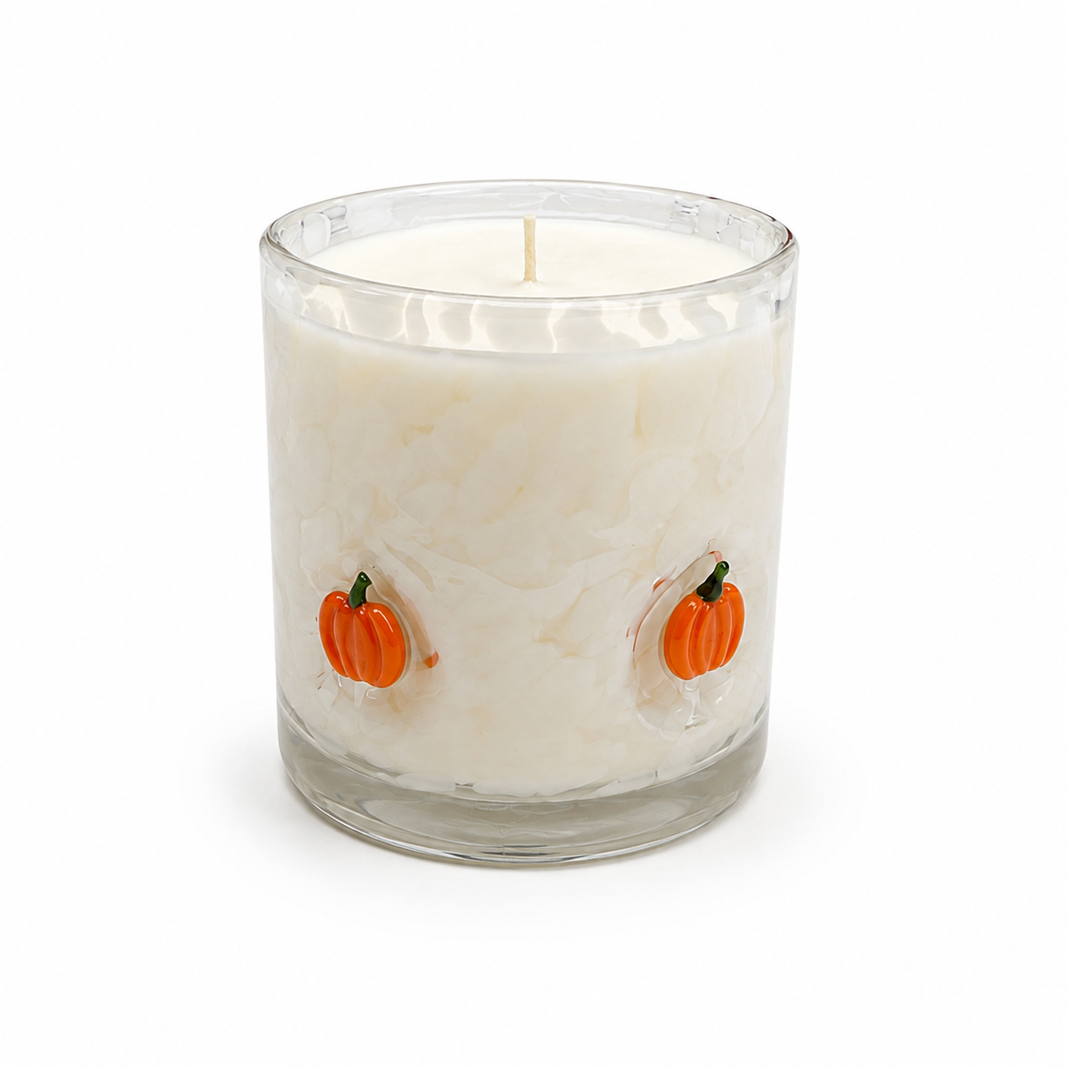 Halloween artisan candle with orange glass pumpkins on a cream vessel