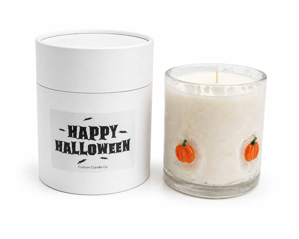 Pumpkin Halloween candle beside its Happy Halloween gift tube