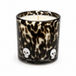 Halloween artisan candle with white skulls on a black speckled glass vessel
