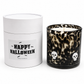 Skull Halloween candle beside its Happy Halloween gift tube