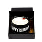 The "Happy Birthday" Candle Gift Box Set includes a white natural wax candle in a black mug labeled "HAPPY BIRTHDAY," topped with a small red bow.