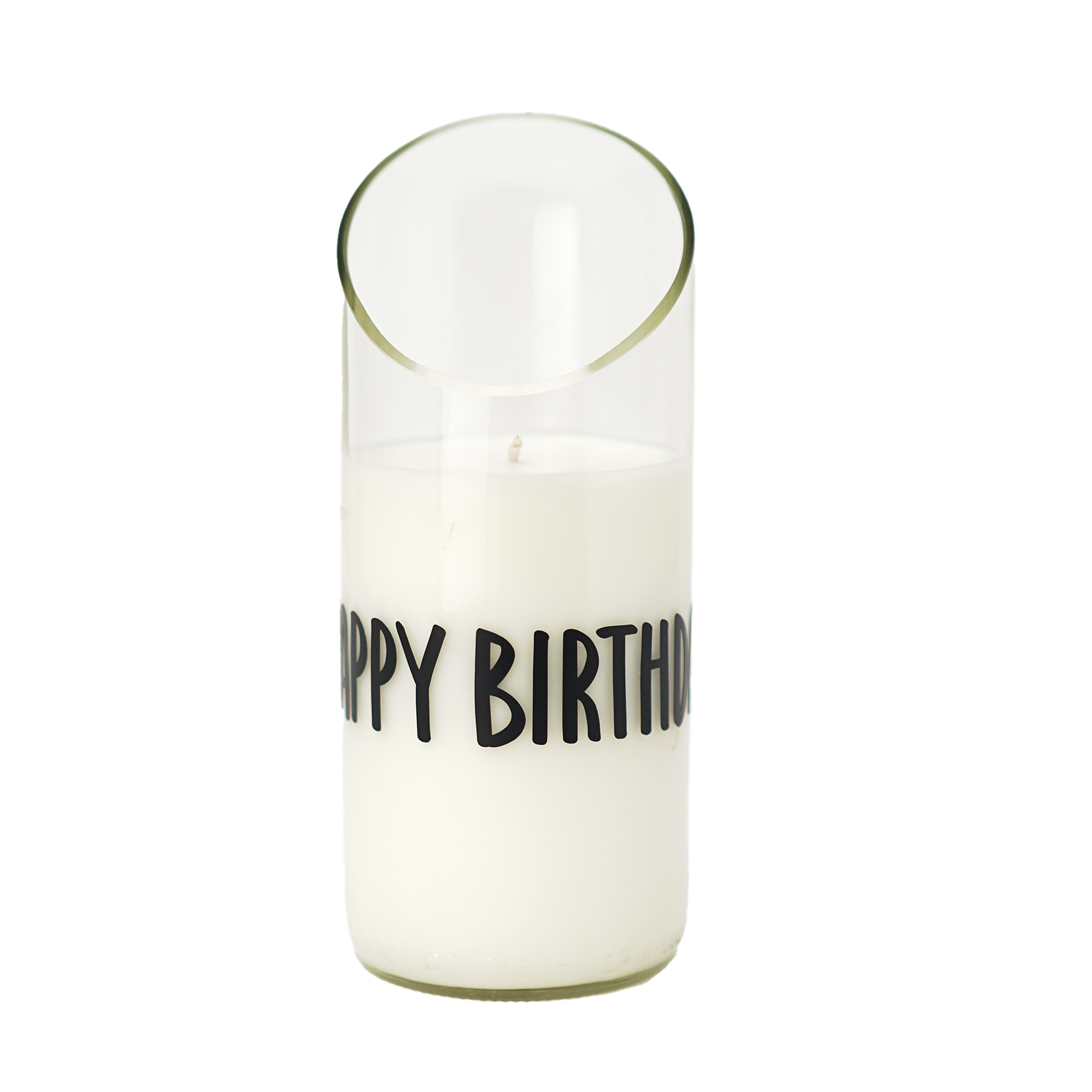 The "Happy Birthday" Recycled Curve Cut Candle, made from natural wax, sits in a clear glass holder with "HAPPY BIRTHD" in black letters and features a slanted top edge.
