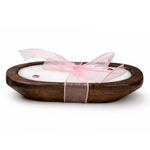 The Pink Ribbon - Dough Bowl Candle is a hand-poured soy candle in a wooden bowl, adorned with a pink ribbon and decorative beads, displayed on a white background.