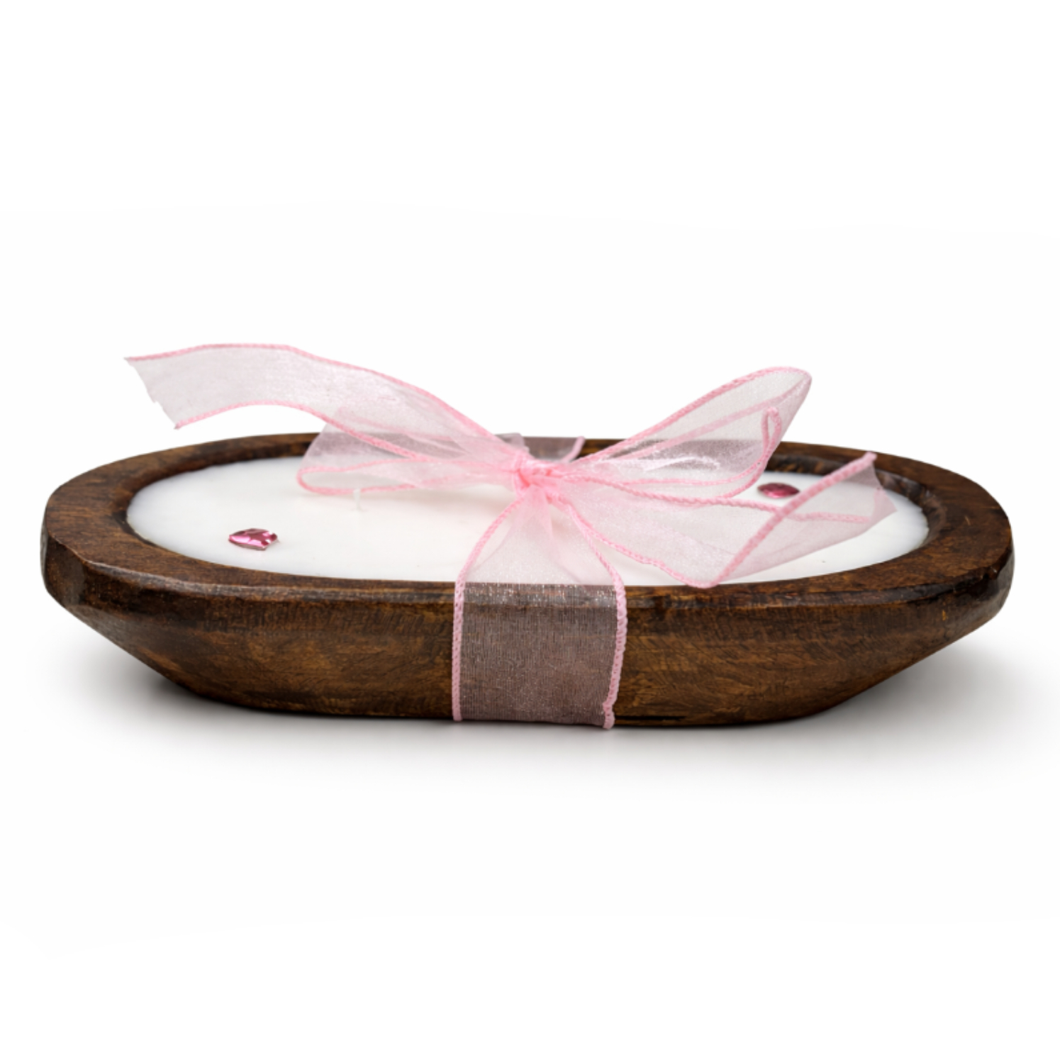 The Pink Ribbon - Dough Bowl Candle is a hand-poured soy candle in a wooden bowl, adorned with a pink ribbon and decorative beads, displayed on a white background.