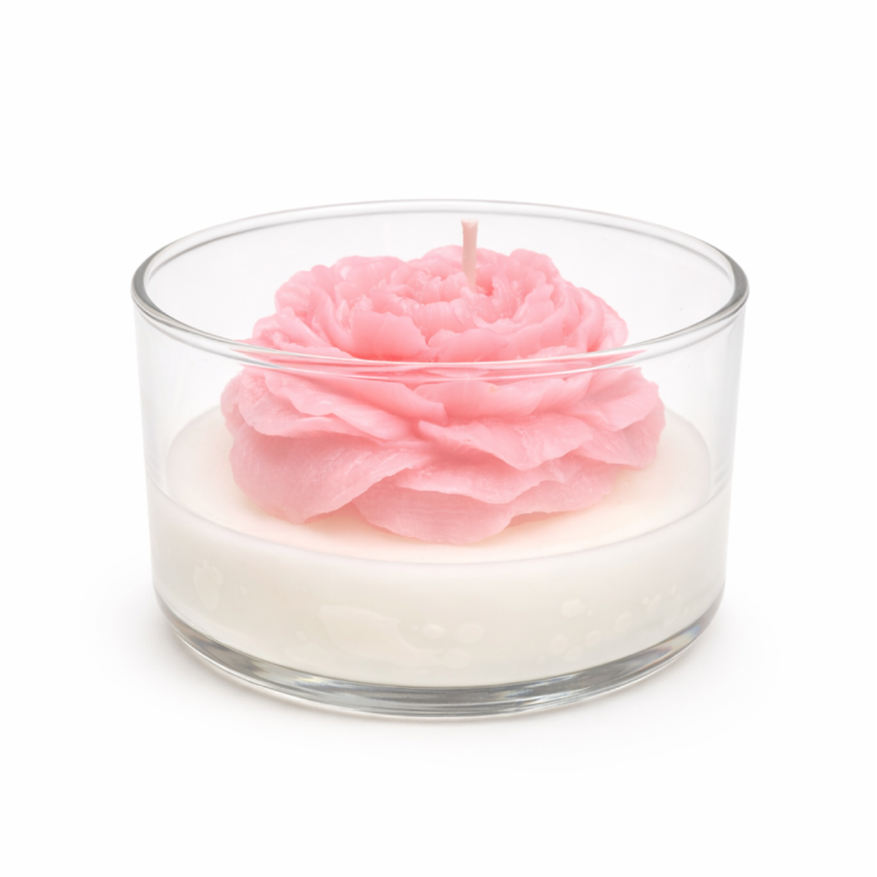 Pink flower-shaped candle in a glass container on a white background