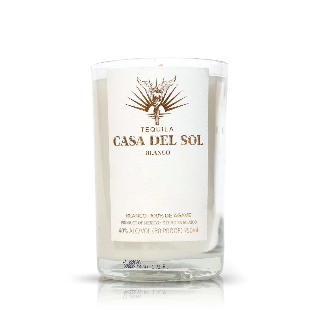 A clear bottle of Recycled Blanco Tequila Candle, crafted from a 750ml Casa Del Sol bottle with a white and gold label marked 100% agave, 40% alcohol by volume.