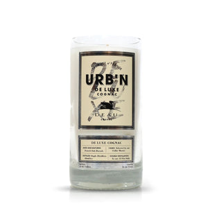 The Recycled Urbn De Luxe Cognac Candle features a clear glass container made from recycled cognac bottles, blending sophisticated design with eco-friendly appeal.