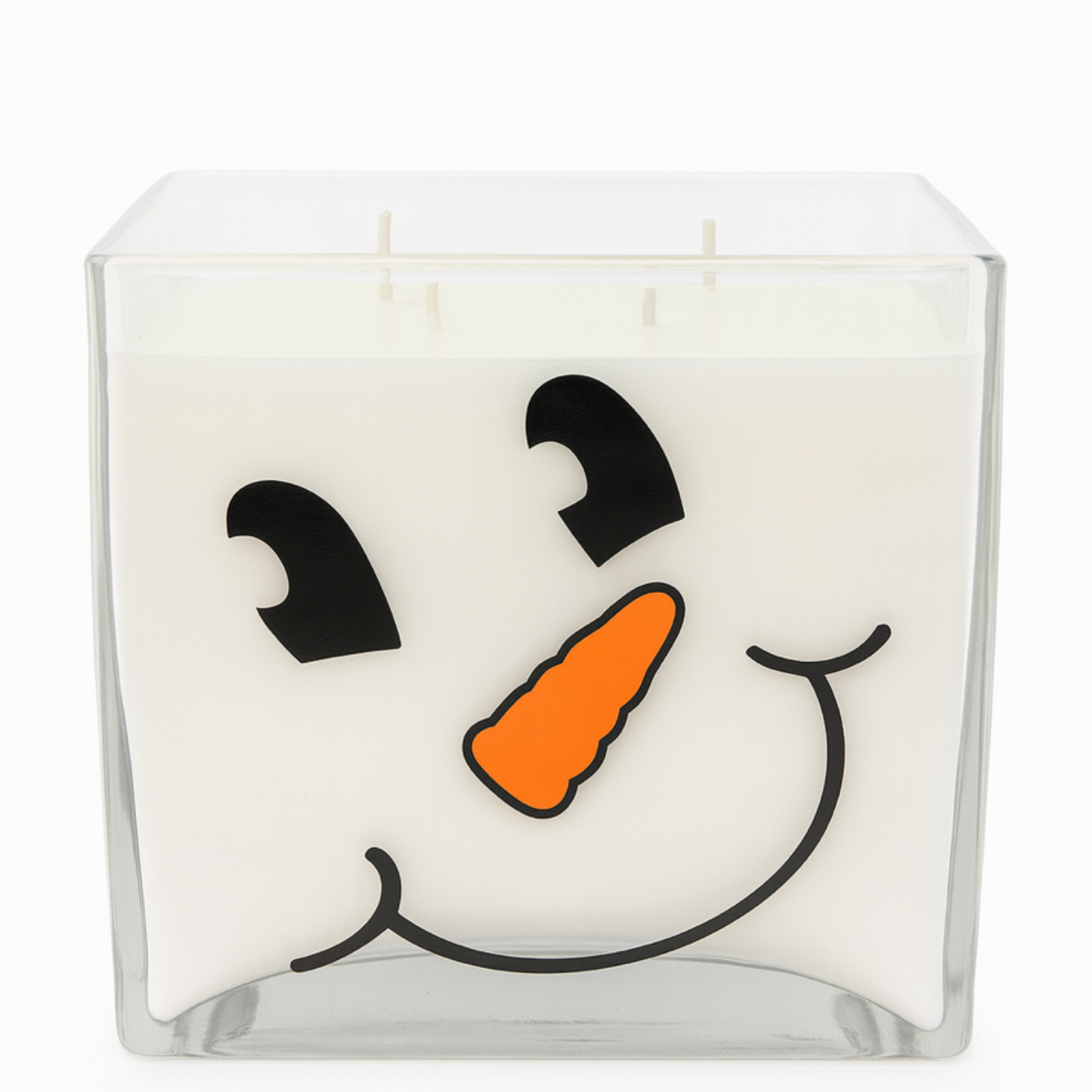 The 4-Wick Smiling Snowman Candle in a square glass jar features a cheerful cartoon face with an orange carrot nose—ideal holiday décor to brighten any room.