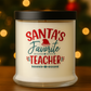 The Santa's Favorite Teacher Candle with Matches is a white, all natural wax candle in a glass jar with a black lid, labeled in festive red and green.