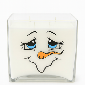 The 4-Wick Snowman Candle is a square glass candle with all-natural white wax and features a cartoon snowman face with blue eyes and an orange carrot nose—perfect for holiday décor.