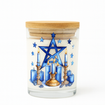 The Star of David Candle is a handmade soy candle in a glass jar with a wooden lid, featuring blue tones, brass candle holder accents, and a blue pentagram—an ideal unique choice for Hanukkah festive celebrations.