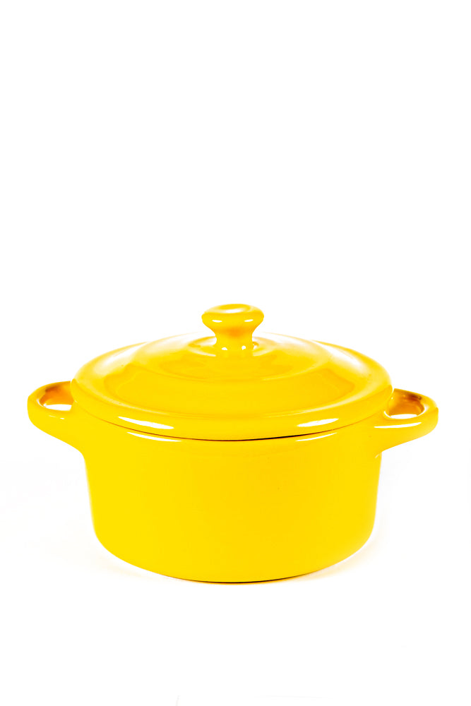The Yellow Mini Cereal Crockpot Candle is a fruity scented soy candle in a yellow ceramic dutch oven with handles and lid, ideal for a charming mini cereal crockpot candle experience.
