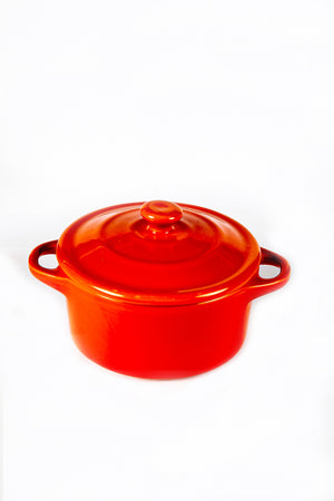 A Red Mini Cereal Crockpot Candle with a lid and two side handles sits on a plain white background.