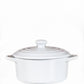 The White Mini Cereal Crockpot Candle is a white ceramic dish with handles and a lid, designed to resemble a stylish crockpot candle, shown against a plain white background.