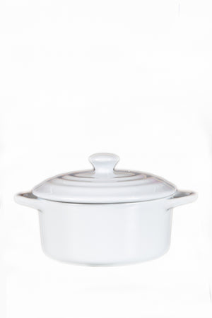The White Mini Cereal Crockpot Candle is a white ceramic dish with handles and a lid, designed to resemble a stylish crockpot candle, shown against a plain white background.