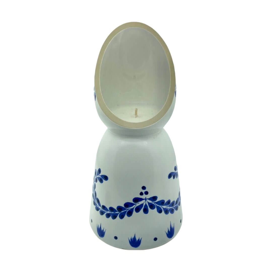 The Recycled Azul Tequila Curve Cut Candle is a white ceramic holder with blue floral patterns, an upright oval-shaped back, and includes a hand-poured soy candle.