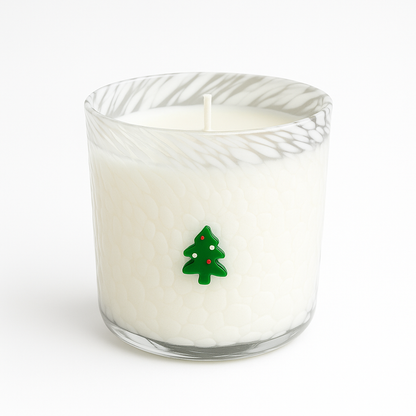 The Christmas Tree Glass Candle features a white holiday candle in a textured glass holder with a small green Christmas tree on the front. A perfect festive accent for your home décor, shown against a plain white background.