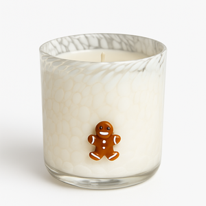 The Gingerbread Man Glass Candle features a white, natural wax gingerbread man in a textured glass container, making it perfect for cozy holiday décor.