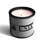 A white natural soy candle called "The Unit - Promotional Tin Candle" in a metal tin with a single flame, shown on a white background.